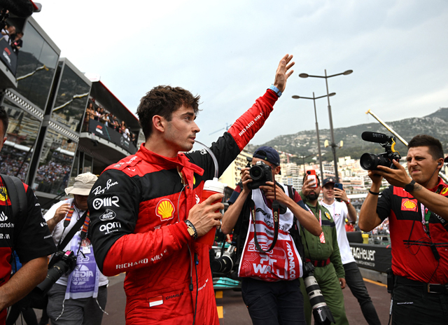 Ferrari’s Monegasque driver Charles Leclerc waves in the pit area after the qualifying session on Saturday at the Monaco street circuit in Monaco, ahead of the Monaco Formula 1 Grand Prix on Sunday  (AFP photo by Christian Bruna)