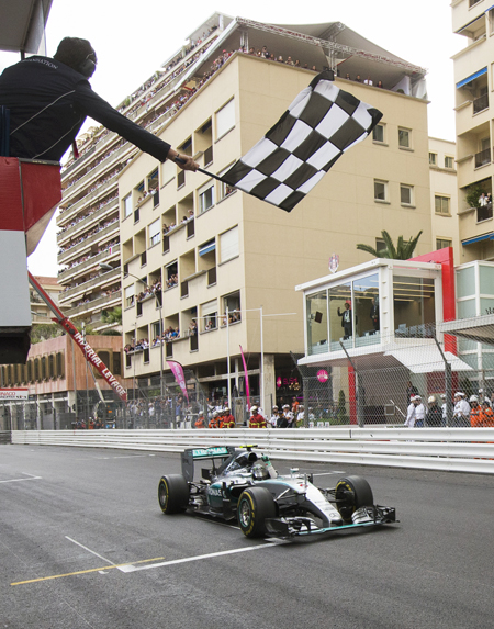 Mercedes driver Nico Rosberg of Germany passes the chequered flag to win the Formula One Grand Prix of Monaco at the Monaco racetrack in Monaco on Sunday (AP photo by Gero Breloer)