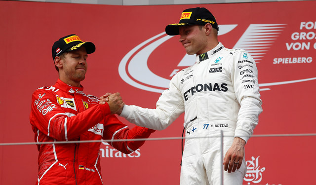 Mercedes’ Valtteri Bottas celebrates his win on the podium with Ferrari’s Sebastian Vettel after the Austrian Grand Prix in Spielberg, Austria, on Sunday  (Reuters photo by Dominic Ebenbichler)