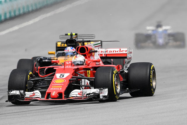 Ferrari’s German driver Sebastian Vettel drives his car during the Formula One Malaysia Grand Prix in Sepang on Sunday  (AFP photo by Mohd Rasfan)