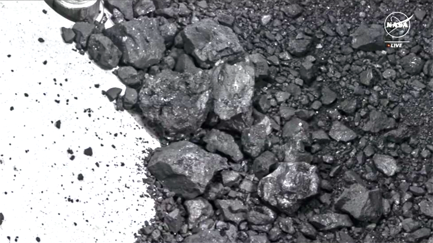 The first images of black dust and pebbles were revealed  (AFP photo)