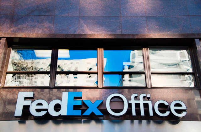   A general view of the sign for FedEx Office in Washington, DC, taken on December 30, 2014. FedEx warned on Tuesday that its fiscal 2020 earnings outlook remains clouded by trade war uncertainty as the company’s chief executive criticised the Trump administration’s lurch towards protectionism (AFP file photo)