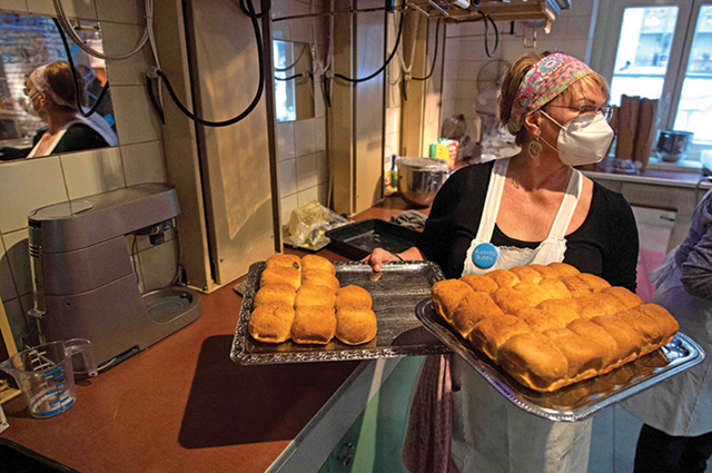 A grandmother holds trays with 'Buchteln' at Vienna’s Vollpension cafe  (AFP photo)