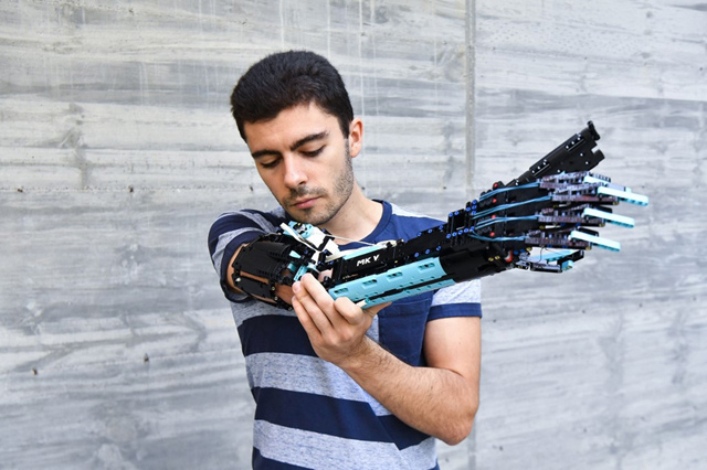 2017 Guinness World record holder and 2020 Lego Masters France winner, David Aguilar, poses with his self-built prosthetic arm, made with Lego pieces, in Sant Cugat del Valles, near Barcelona, on September 9 (AFP photo by Pau Barrena)