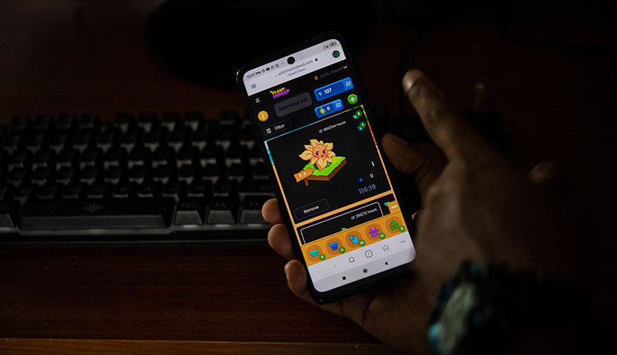 Zacary Egea shows his mobile while checking the status of his plant while playing the Plant Vs Undead video game in the Cuaricuao neighbourhood in the Libertador municipality of Caracas  (AFP photo)