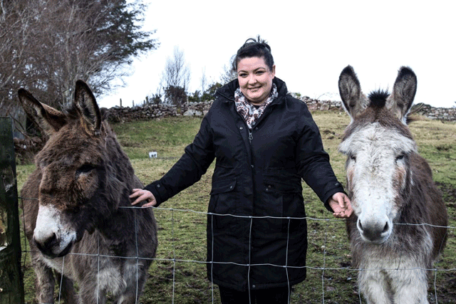 ‘The Banshees of Inisherin’ film extra Madeline Condell, poses with her donkeys, on the Achill island, off the west coast of Ireland, on January 31 (AFP photo by Paul Faith)
