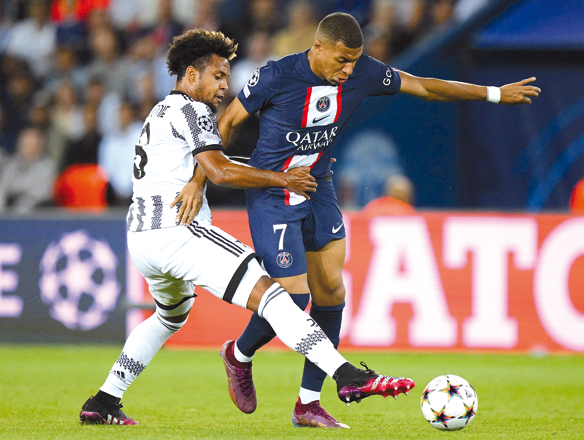 Paris Saint-Germain’s Kylian Mbappe and Juventus’ Weston McKennie (left) fight for the ball during their UEFA Champions League Group H first leg match in Paris on Tuesday  (AFP photo by Anne-Christine Poujoulat)