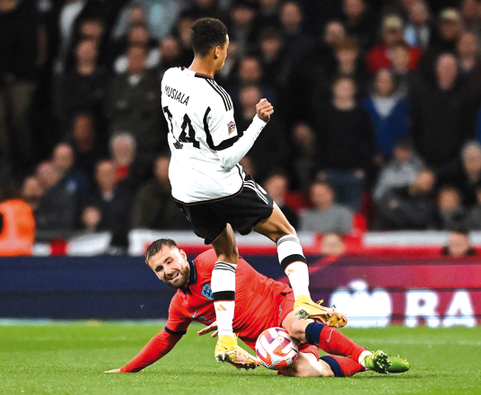England’s defender Luke Shaw (left) vies with Germany’s midfielder Jamal Musiala during their UEFA Nations League group A3 match in London on Monday  (AFP photo by Ben Stansall)