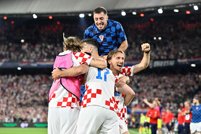 Croatia’s midfielder Luka Modric (right) celebrates with teammates after scoring against The Netherlands during the UEFA Nations League semifinal match in Rotterdam on Wednesday (AFP photo by John Thys)