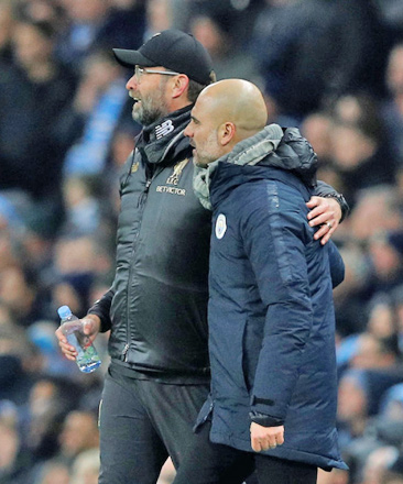 Manchester City manager Pep Guardiola and Liverpool manager Juergen Klopp talk to each other during their Premier League match at the Etihad Stadium in Manchester on January 3  (Reuters photo)