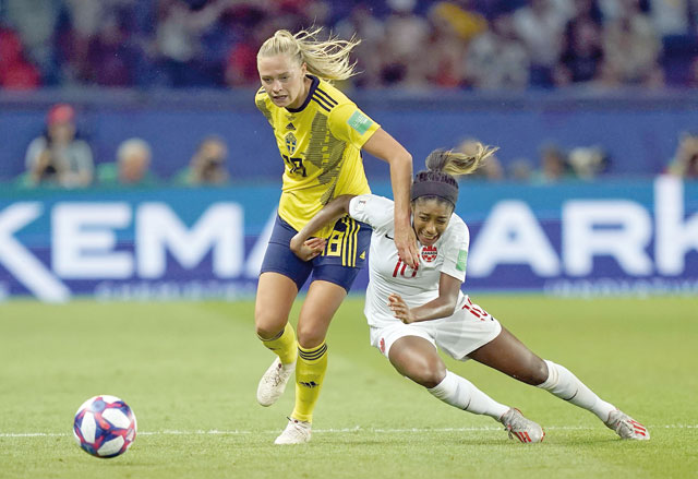 Sweden’s forward Fridolina Rolfo (left) vies with Canada’s defender Ashley Lawrence during their France 2019 Women’s World Cup football match in Paris on Monday (AFP photo by Kenzo Tribouillard)