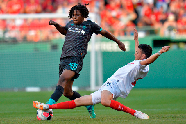 Sevilla’s Sebastien Mathieu Corchia (right) slide tackles Liverpool’s Yasser Larouci during their pre-season friendly match at Fenway Park in Boston on Sunday (AFP photo by Joseph Prezioso)