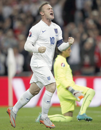 England’s striker Wayne Rooney celebrates after scoring from the penalty spot to score his 50th goal for England, making him the country’s all-time goal scorer, during a Euro 2016 match at Wembley Stadium in west London, on Tuesday (AFP photo by Adrian Dennis)