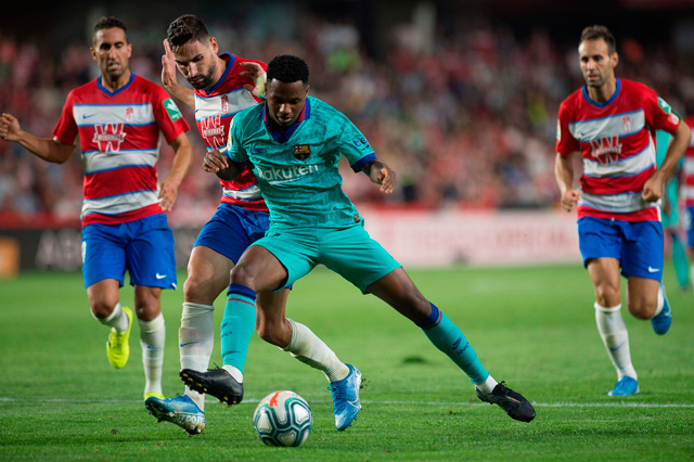 Granada’s Spanish midfielder Antonio Puertas (second left) vies with Barcelona’s Guinea-Bissau forward Ansu Fati during their Spanish league football match in Granada on Saturday  (AFP photo by Jorge Guerrero)