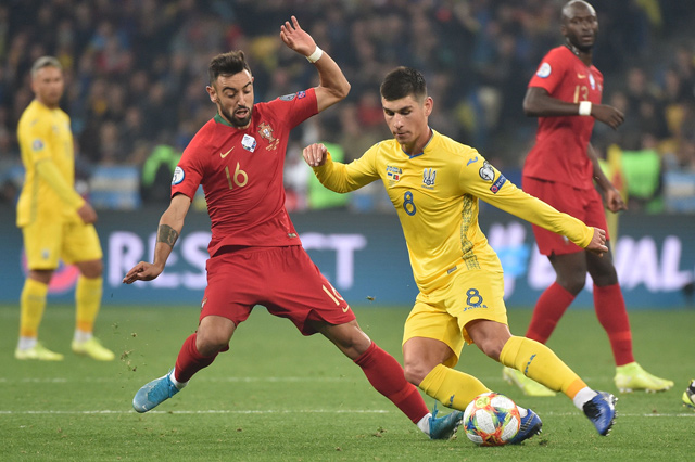 Portugal’s midfielder Bruno Fernandes and Ukraine’s midfielder Ruslan Malinovskyi vie for the ball during their Euro 2020 qualification match in Kiev on Monday (AFP photo by Genya Savilov)