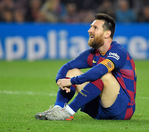Barcelona’s Argentine forward Lionel Messi sits on the field during the Spanish league football match against Real Valladolid in Barcelona on Tuesday  (AFP photo by Lluis Gene)
