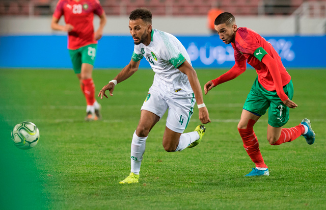Morocco’s midfielder Hakim Ziyech (right) vies for the ball with Mauritania’s defender Houssen Abderrahmane during the 2021 Africa Cup of Nations group E qualifying football match in Rabat on Friday (AFP photo by Fadel Senna)