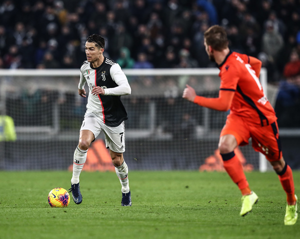 Juventus’ Portuguese forward Cristiano Ronaldo runs with the ball against Udinese during the Italian Serie A football match in Turin on Sunday  (AFP photo by Isabella Bonotto)