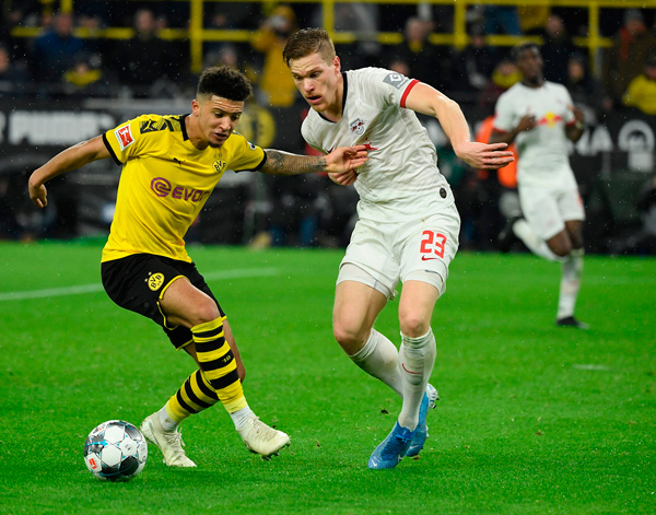 Borussia Dortmund’s English forward Jadon Sancho (left) and Leipzig’s Marcel Halstenberg vie for the ball during their German first division Bundesliga football match in Dortmund on Tuesday  (AFP photo by Ina Fassbender)