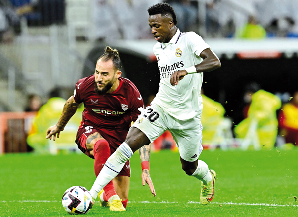 Sevilla’s Serbian midfielder Nemanja Gudelj (left) fights for the ball with Real Madrid’s Brazilian forward Vinicius Junior during their Spanish league match in Madrid on Saturday  (AFP photo by Javier Soriano)