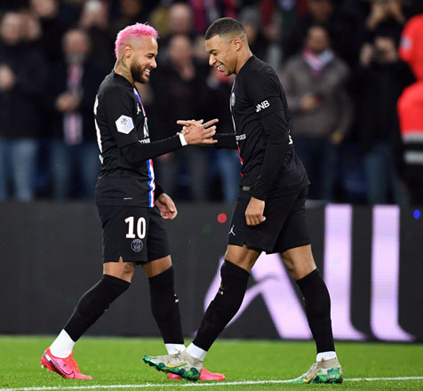 Paris Saint-Germain’s French forward Kylian Mbappe (right) is congratulated by teammate Brazilian forward Neymar after scoring a goal during their French L1 match against Montpellier Herault SC in Paris on Saturday (AFP photo by Martin Bureau)