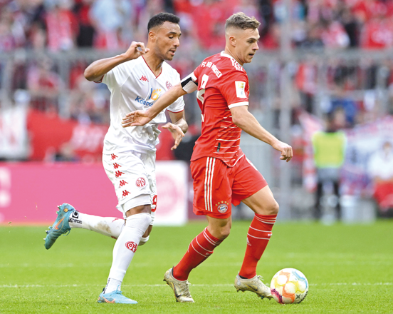 Bayern Munich’s Joshua Kimmich (right) and Mainz’ Karim Onisiwo vie for the ball during their German first division Bundesliga match in Munich on Saturday (AFP photo by Christof Stache)