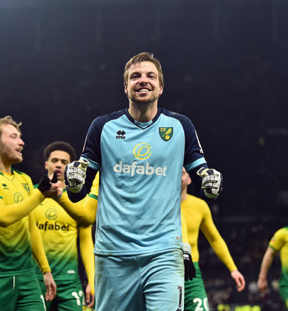 Norwich City’s Dutch goalkeeper Tim Krul celebrates with his teammates after winning the English FA Cup fifth round football match against Tottenham Hotspur in London on Wednesday (AFP photo by Glyn Kirk)