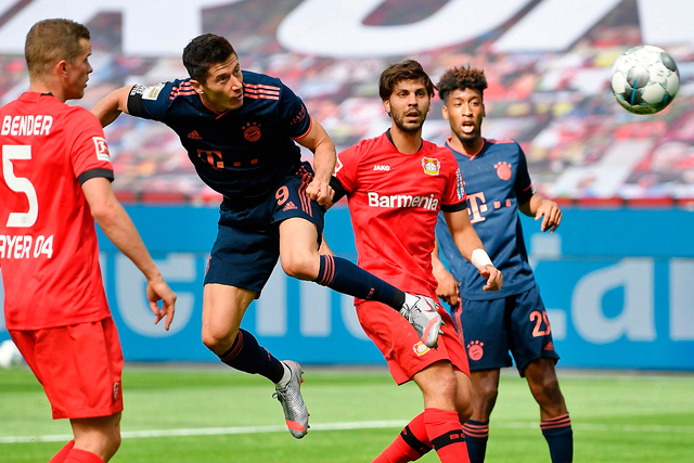 Bayern Munich’s Polish forward Robert Lewandowski (centre) heads to score against Leverkusen during their German first division Bundesliga football match in Leverkusen, Germany, on Saturday (AFP photo by Matthias Hangst)