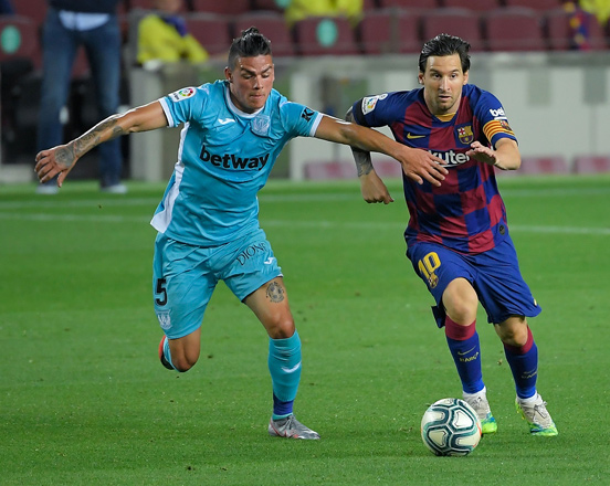 Leganes’ Argentinian defender Jonathan Silva (left) challenges Barcelona’s Argentine forward Lionel Messi during their Spanish league football match in Barcelona on Tuesday  (AFP photo by Lluis Gene)