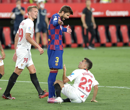 Barcelona’s Spanish defender Gerard Pique (2nd right) argues with Sevilla’s Spanish defender Sergio Reguilon (right) during their Spanish league football match in Seville on Friday  (AFP photo by Cristina Quicler)