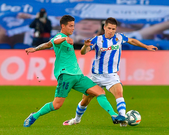 Real Madrid’s Colombian midfielder James Rodriguez (left) vies with Real Sociedad’s Spanish midfielder Igor Zubeldia during their Spanish League match in San Sebastian on Sunday  (AFP photo by Ander Gillenea)