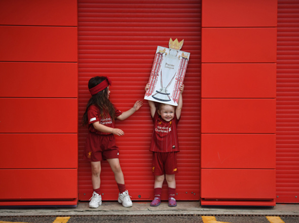 Children celebrate Liverpool winning the Premier League title (AFP photo)