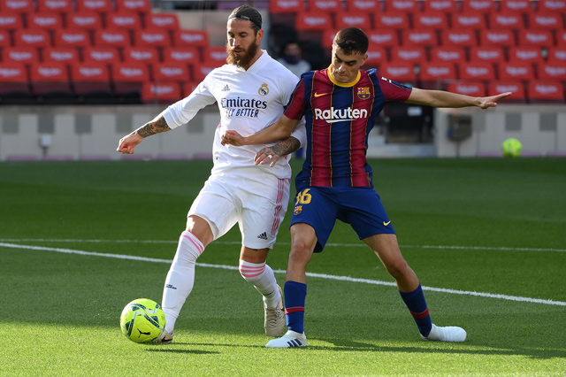 Barcelona’s midfielder Pedri (right) challenges Real Madrid’s defender Sergio Ramos during their Spanish League match in Barcelona on Saturday (AFP photo by Lluis Gene)
