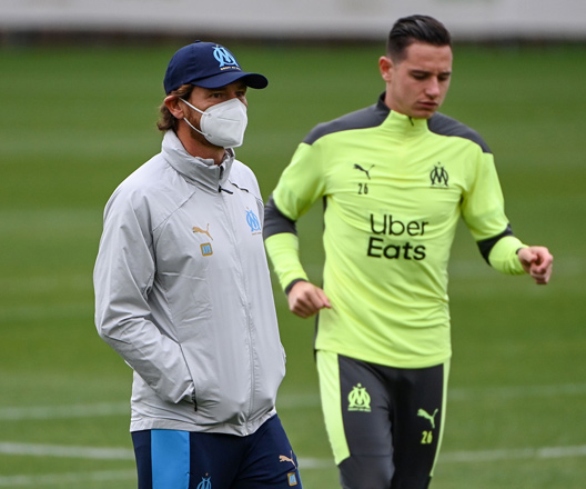 Marseille’s Portuguese coach Andre Villas- Boas walks next to French forward Florian Thauvin at the training camp of Marseille on Monday, on the eve of their Champions League match against Manchester City  (AFP photo by Christophe Simon)
