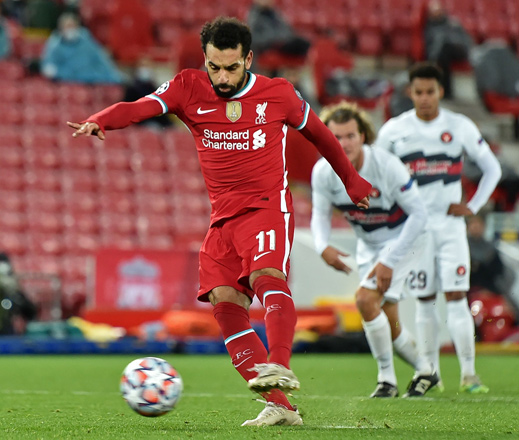 Liverpool’s Egyptian midfielder Mohamed Salah scores against Midtjylland from the penalty spot during the UEFA Champions League Group D match in Liverpool, England, on Tuesday  (AFP photo by Peter Powell)