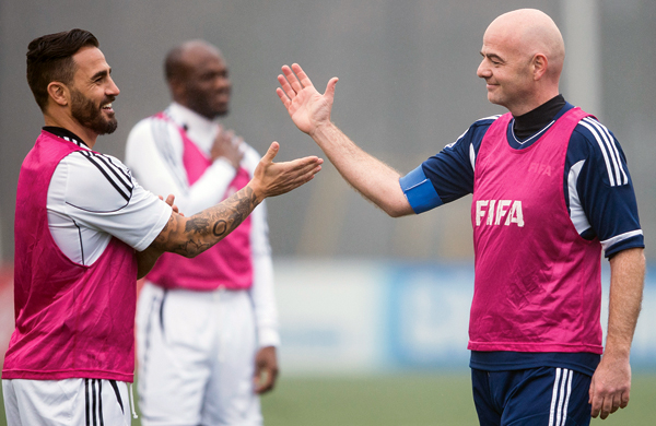 New FIFA President Swiss Gianni Infantino (right) prepares to clap hands with former Italian football player Fabio Cannavaro during a friendly match at the home of FIFA in Zurich, Switzerland, on Monday (AP photo by Ennio Leanza)