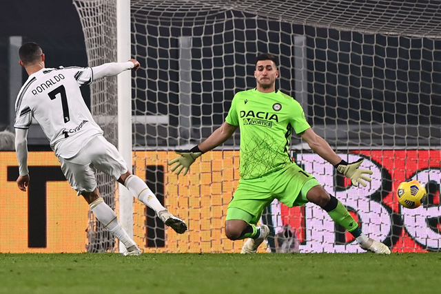 Juventus’ Portuguese forward Cristiano Ronaldo (left) scores his second goal past Udinese’s Argentine goalkeeper Juan Musso during their Italian Serie A match in Turin on Sunday (AFP photo by Marco Bertorello)