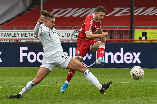 Crawley Town’s defender Nick Tsaroulla (right) shoots past Leeds United’s midfielder Kalvin Phillips to score during their English FA Cup third round match in Crawley on Sunday (AFP photo by Glyn Kirk)