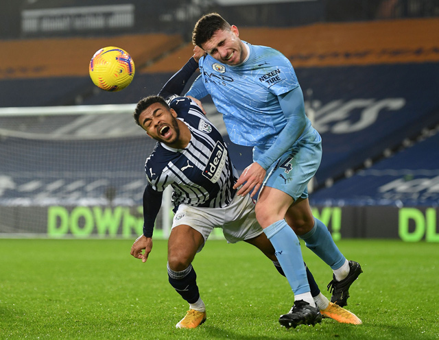Manchester City’s French defender Aymeric Laporte (right) vies with West Bromwich Albion’s English striker Callum Robinson during their English Premier League match in West Bromwich on Tuesday (AFP photo by Michael Regan)  