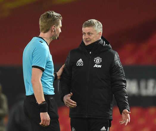 Manchester United’s Norwegian manager Ole Gunnar Solskjaer (right) talks with referee Lawrence Visser at the end of the UEFA Europa League Round of 32, 2nd leg football match against Real Sociedad in Manchester, England, on Thursday  (AFP photo by Oli Scarff)