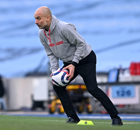Manchester City manager Pep Guardiola returns the ball against Manchester United during their English Premier League match in Manchester on March 7 (AFP photo)