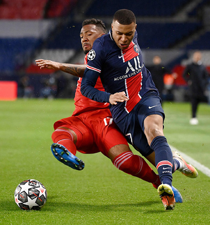 Paris Saint-Germain’s forward Kylian Mbappe (right) fights for the ball with Bayern Munich’s defender Jerome Boateng during their UEFA Champions League quarter-final second leg in Paris, on Tuesday  (AFP photo by Franck Fife)