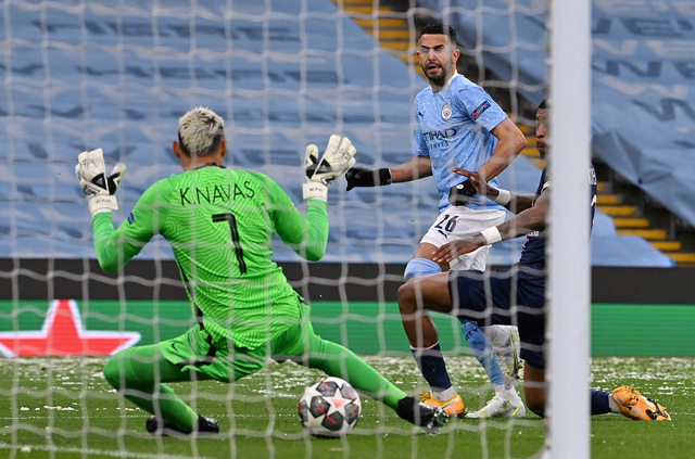 Manchester City’s midfielder Riyad Mahrez (centre) scores against Paris Saint-Germain during their Champions League second leg semifinal match in Manchester, England, on Tuesday  (AFP photo by Paul Ellis)