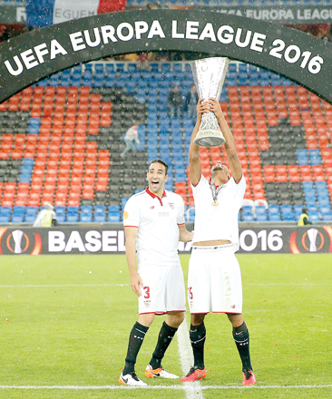 Sevilla players Adil Rami (left) and Steven N’Zonzi celebrate with the trophy after the football Europa League final against England’s Liverpool FC in Basel, Switzerland, on Wednesday (AP photo by Peter Klaunzer)
