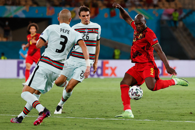 Portugal’s midfielder Joao Palhinha (centre) challenges Belgium’s forward Romelu Lukaku (right) during their UEFA Euro 2020 round of 16 match in Seville on Sunday (AFP photo by Julio Munoz)