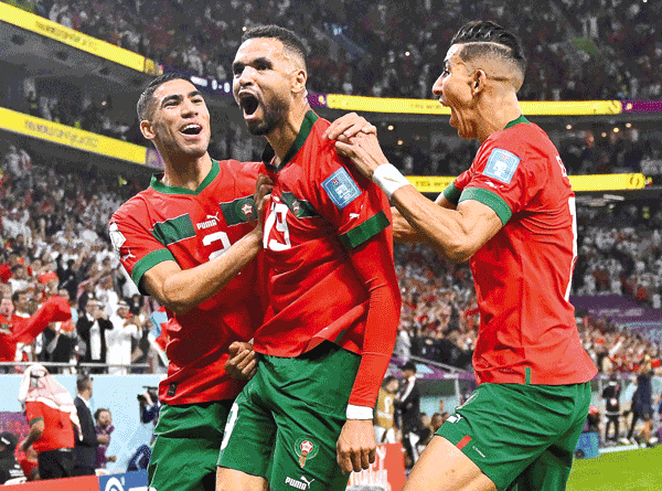Morocco’s forward Youssef En-Nesyri (centre) celebrates with teammates after scoring during their Qatar 2022 World Cup quarter-final against Portugal in Doha on Saturday (AFP photo by Patricia de Melo Moreira)