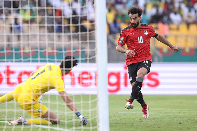 Egypt’s forward Mohamed Salah (right) scores against Morocco during their Africa Cup of Nations quarter-final match in Yaounde on Sunday (AFP photo by Kenzo Tribouillard)