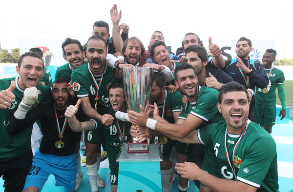 Ahli players celebrate winning the Super Cup title on Friday in Amman (Photo courtesy of the Jordan Football Association)