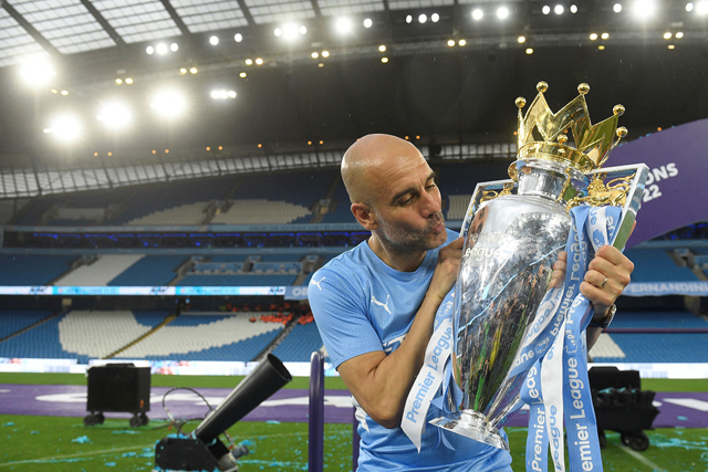Manchester City’s manager Pep Guardiola celebrates with the Premier league trophy after the English Premier League match between against Aston Villa in Manchester on on Sunday (AFP photo by Oli Scarff)