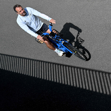 Germany’s headcoach Hansi Flick rides a bicycle as he arrives on Monday for a training session in Munich on the eve of the UEFA Nations League match against England (AFP photo by Christof Stache)